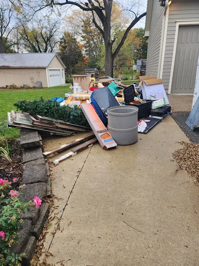 Dumpster being loaded with debris for Estate Cleanout Dumpster Rental in Harpswell